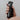 Hand holding an Aromatic Creation black spray bottle labeled 'Wake Up' in front of a shower.